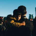 A couple of people that are hugging each other